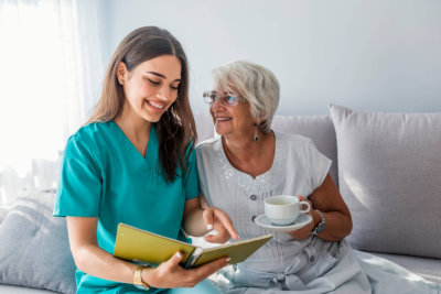 happy patient is holding caregiver for a hand while spending time together