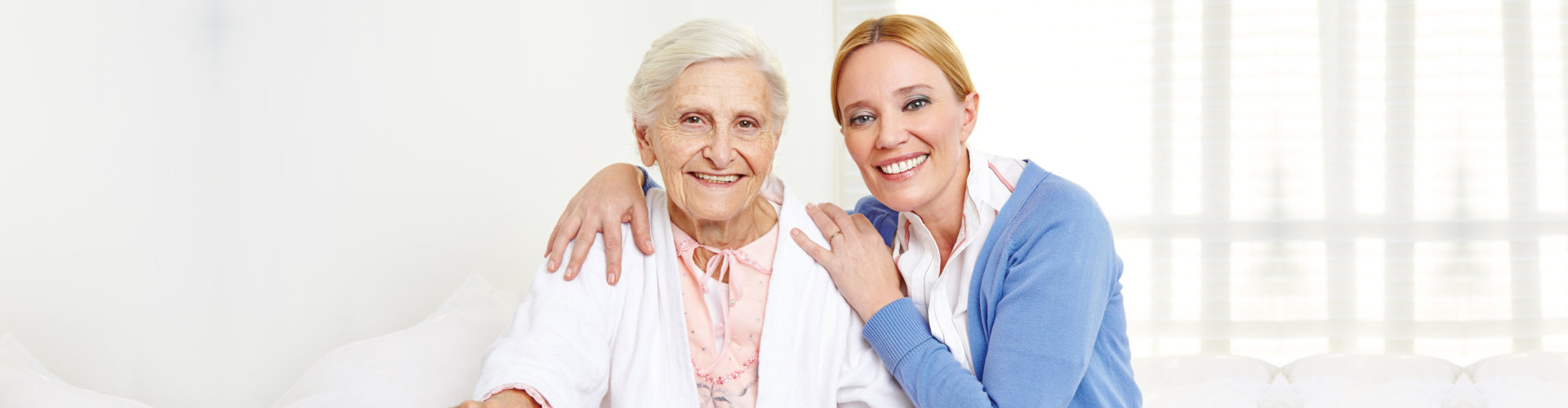 happy senior women at home sitting on the bed