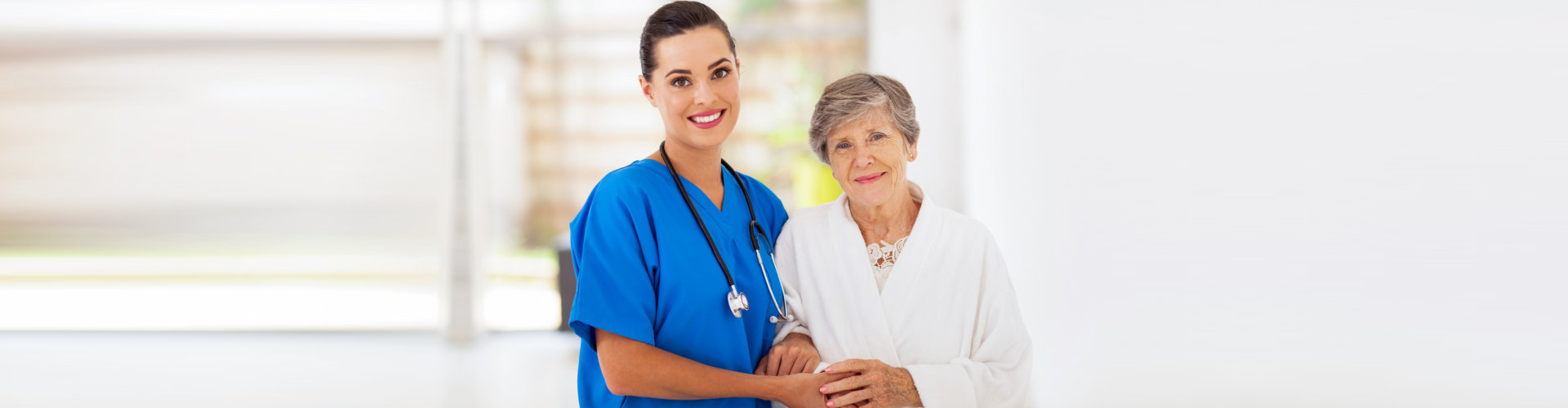 senior women and caring young nurse